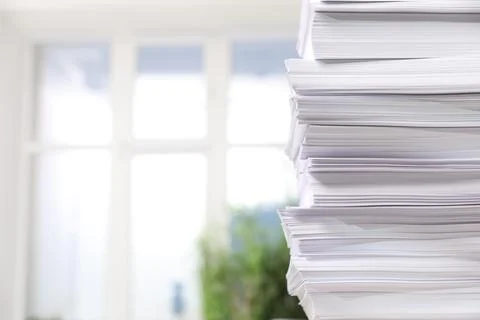 Stack of paper sheets against blurred background, closeup. Space for text 스톡 사진