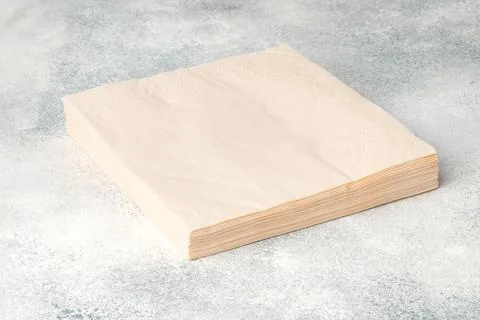 Stack of paper square napkins on gray background 스톡 사진