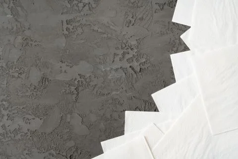 Stack of paper square napkins on gray background Foto stock
