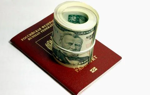 Stack of paper usa dollars and red passport under 스톡 사진