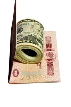 Stack of paper usa dollars inside thr red passport Stock Photos