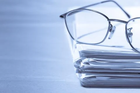Stack of papers and glasses 写真素材