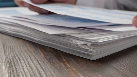 Stack of papers with financial report, charts and figures. Paperwork in the Stock Footage 165265884