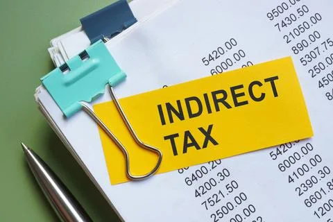 Stack of papers with a note about indirect tax. Stock Photos