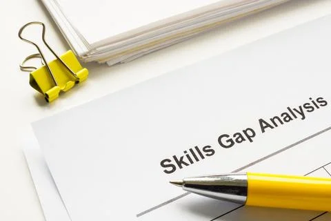 Stack of papers with skills gap analysis. Foto stock