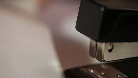 A stack of papers is stapled with a stapler Stock Footage 73450177