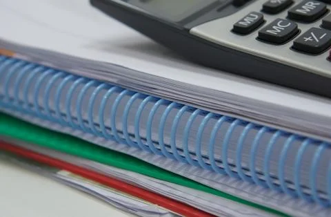 Stack of paperwork and calculator Foto stock