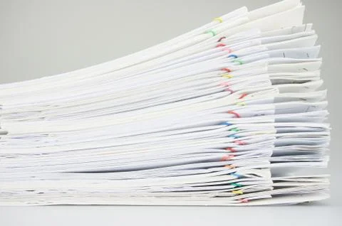 Stack paperwork with colorful paper clip overlap report white background Stock Photos