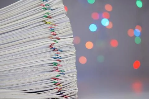 Stack of paperwork have colorful bokeh circle as background Stock Photos