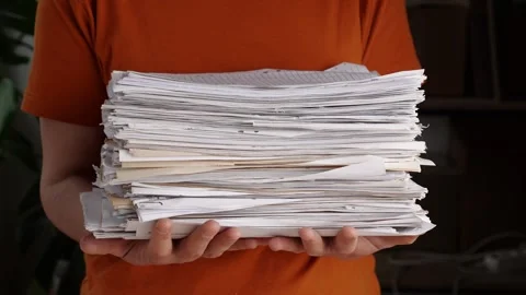 Stack of paperwork. An office worker holds a large stack of paper in his hands Stock Footage 242754930