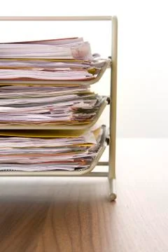 A Stack Of Paperwork Sitting In A Tray Stock Photos