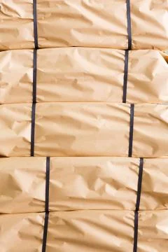Stack of parcel wrapped in brown recycled paper 写真素材