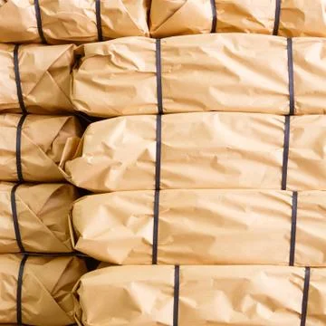 Stack of parcel wrapped in brown recycled paper 스톡 사진