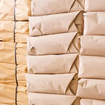 Stack of parcel wrapped in brown recycled paper Stock Photos