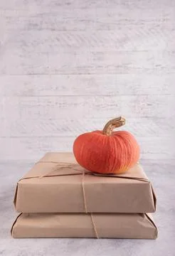 A stack of parcels in craft paper, tied with natural twine, a bright orange p 写真素材