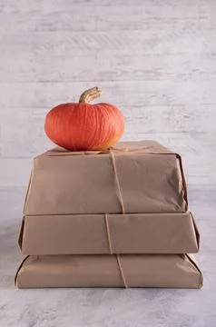A stack of parcels wrapped in kraft paper and tied with jute twine, on top is 写真素材