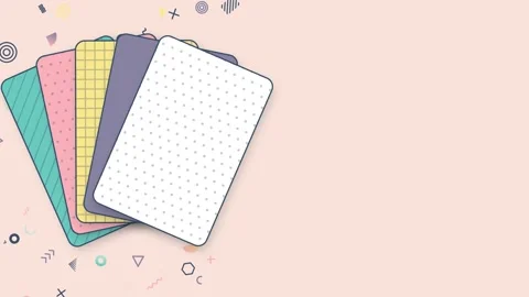 Stack of patterned pastel cards fanning open and closed on the left 库存影片 348277349