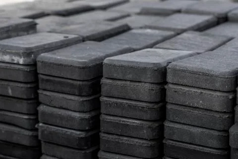 Stack of paving stone on construction site. Bricks for paving stones stacked in Stock Photos