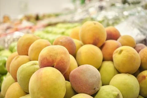 Stack of peaches in a fruit store. Stock Photos