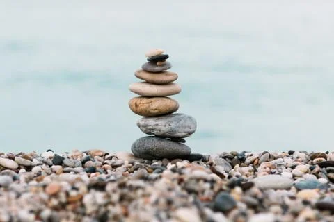 Stack of pebble Stones on ocean background. Peaceful and calm concept Stockfoto's