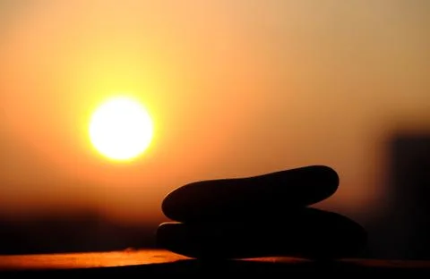 Stack of pebble on yellow sun background Stock Photos