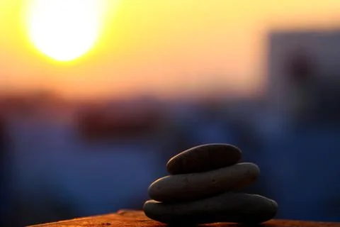 Stack of pebble on yellow sun background Foto stock