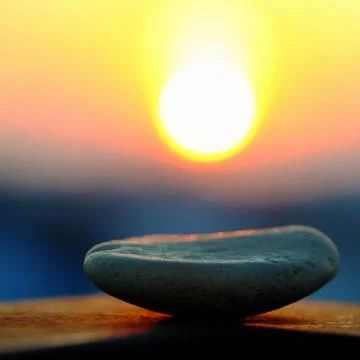 Stack of pebble on yellow sun background Stock Photos