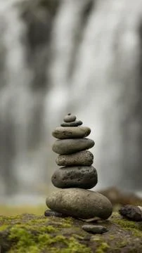 Stack of pebbles and waterfall Stock Photos