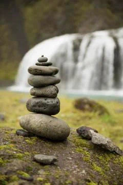 Stack of pebbles and waterfall Stock Photos