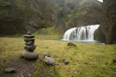 Stack of pebbles and waterfall Stock Photos