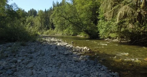 Stack of pebbles on the banks of a river Stock Footage 105410783
