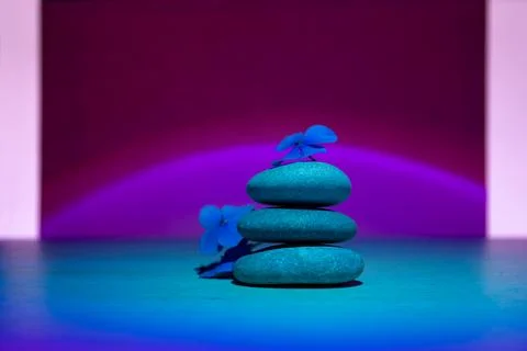 Stack of pebbles with flower, relax calm concept. Ultraviolet background. Stock Photos