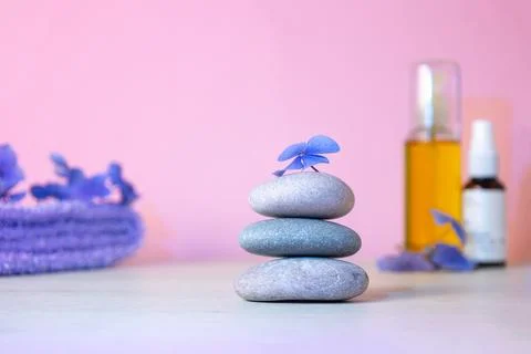 Stack of pebbles, massage oil, towel. Relax calm concept. Stock Photos