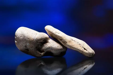 Stack of pebbles. River stone on abstract colored background. Still life with 库存照片
