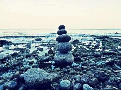 Stack of pebbles on the shore of lake Garda Stock Photos