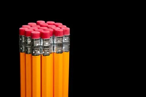 A stack of pencils with red erasers on top Stock Photos