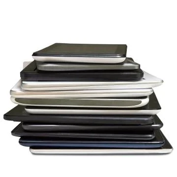 Stack of pending repair of defective tablet isolated on a white background Photos