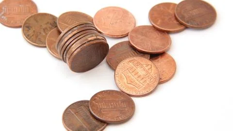 Stack of pennies with others on white isolated Stock Photos