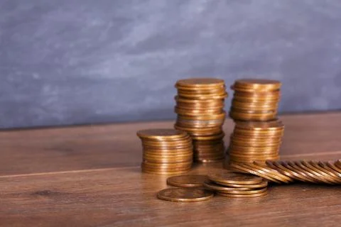 Stack of penny coins on a wooden surface Stock Photos