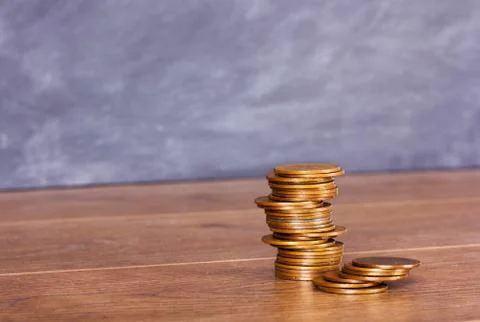 Stack of penny coins on a wooden surface Stock Photos