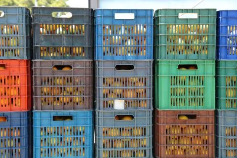 Stack pf plastic crates full of oranges Stock Photos