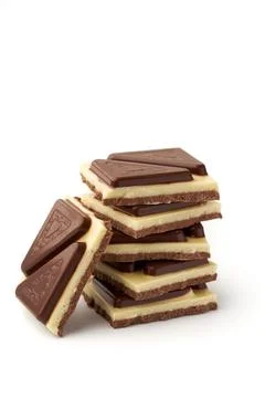 Stack of pieces of milk chocolate isolated on white background Stock Photos