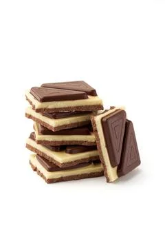 Stack of pieces of milk chocolate isolated on white background Stock Photos