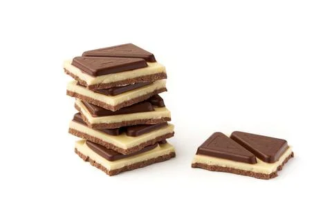 Stack of pieces of milk chocolate isolated on white background Stock Photos