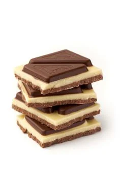 Stack of pieces of milk chocolate isolated on white background Stock Photos