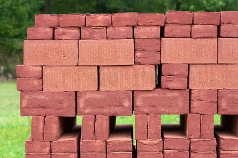 Stack of piled red bricks outside Stock Photos