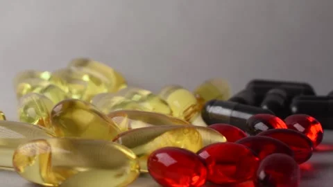 Stack of pills and medicine of various sizes and colors Stock Footage 144893437