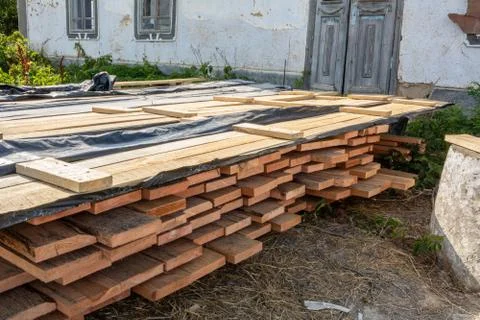 A stack of pine boards soaked in an antiseptic solution is dried at the const Stock Photos