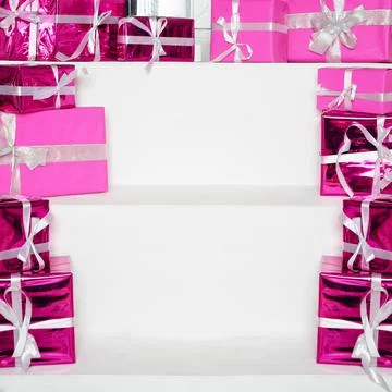 Stack of pink celebration gift boxes with ribbon bows on white table, free sp Stock Photos