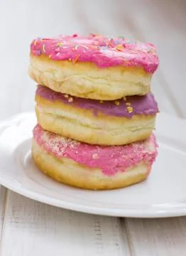 The stack of pink donuts on a white plate Stock Photos